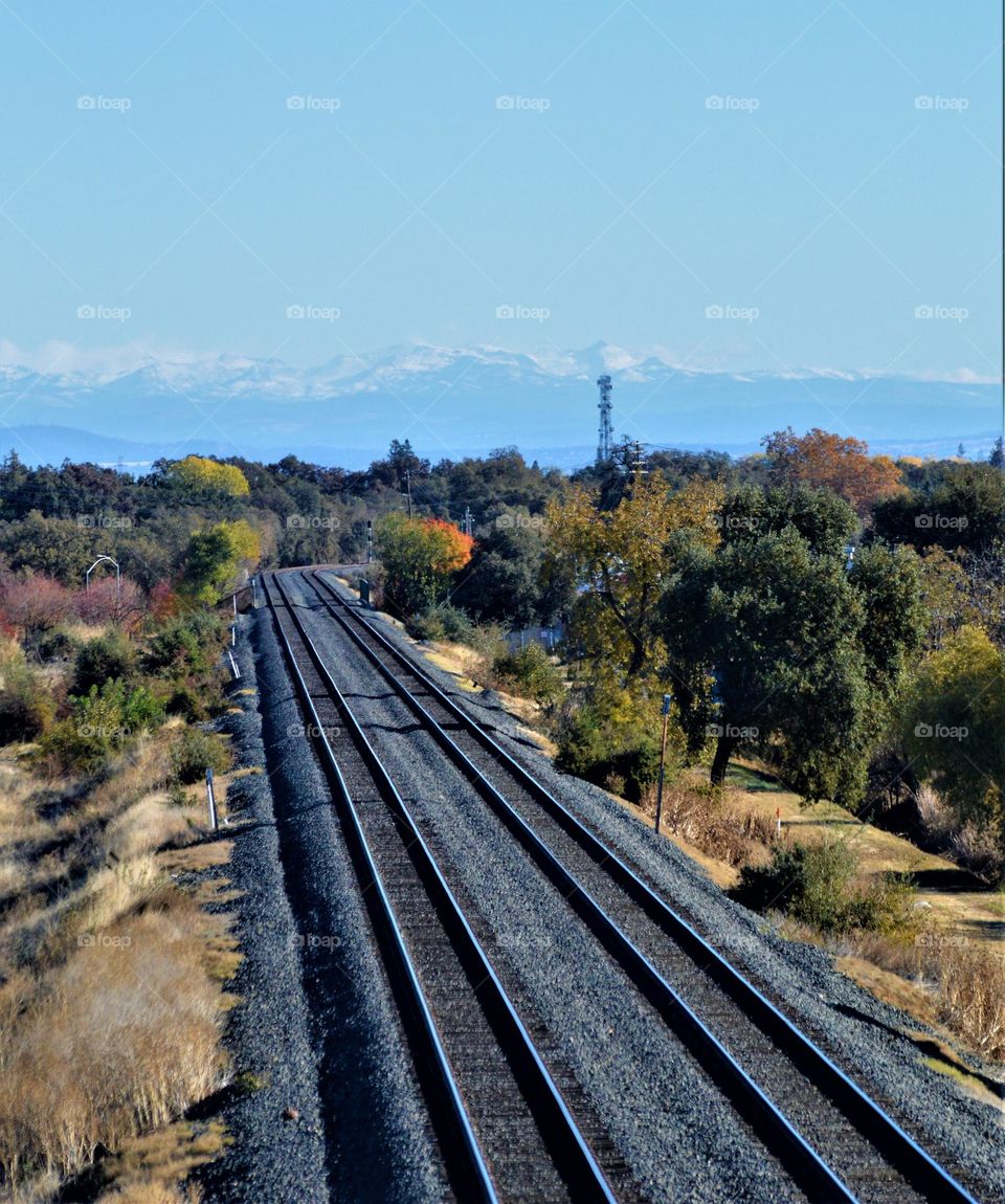 A view from a overhead bridge of train tracks