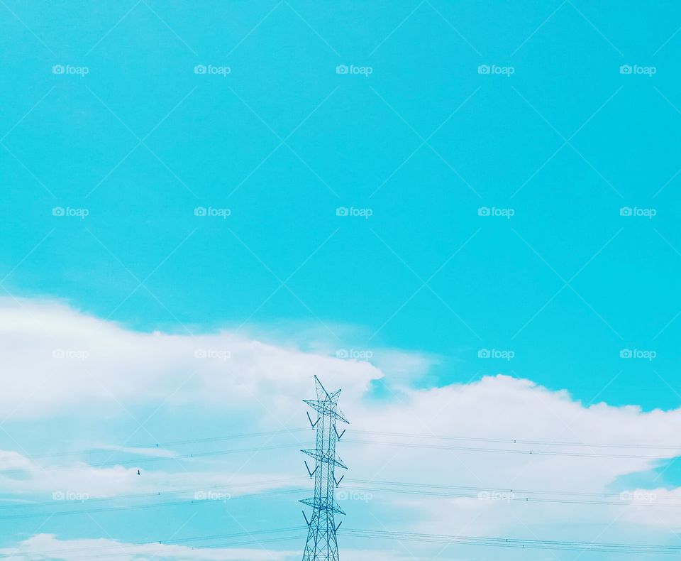 the electric poles in the blue sky