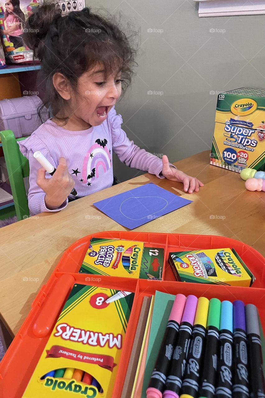 Little girl is excited to color, making art for uncles, creating a thank you note for Christmas gifts 