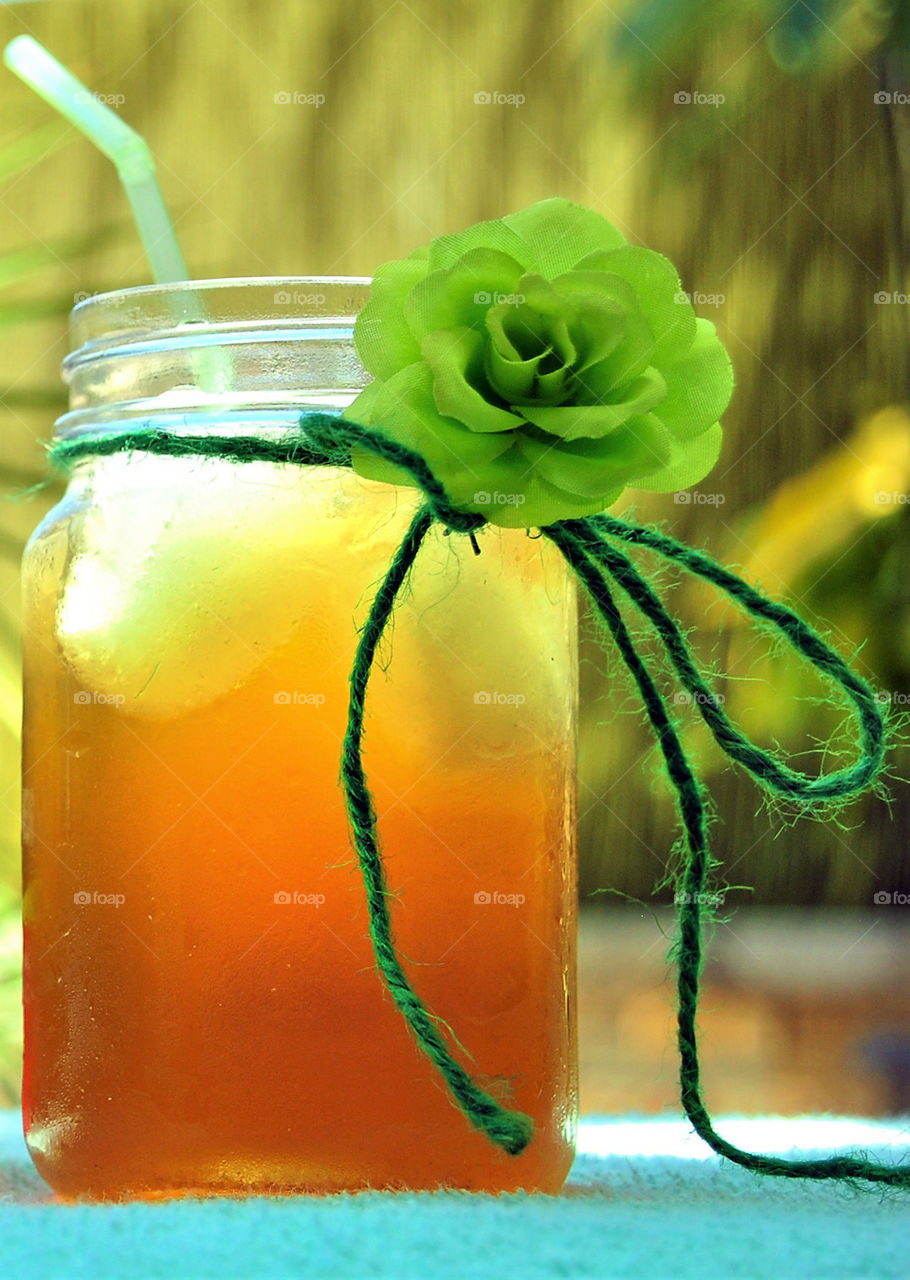 Jar of juice decorated with fake flower
