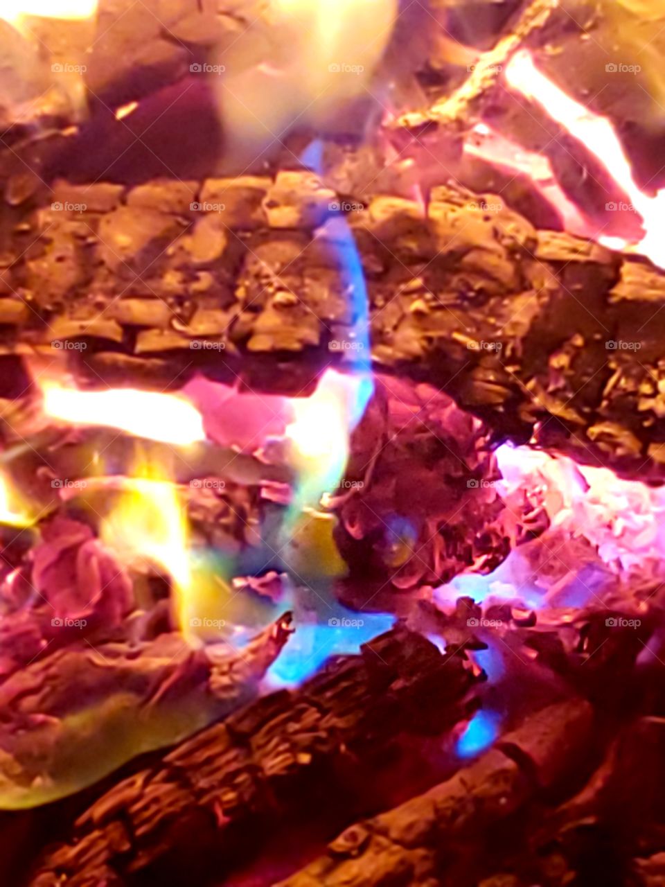 close up of colored flames in a campfire