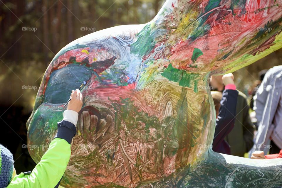 Children decorate the Easter Bunny.