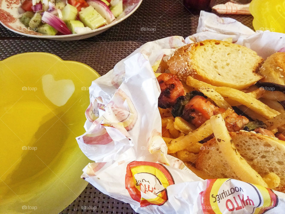 souvlakis, bread, fries and greek salad