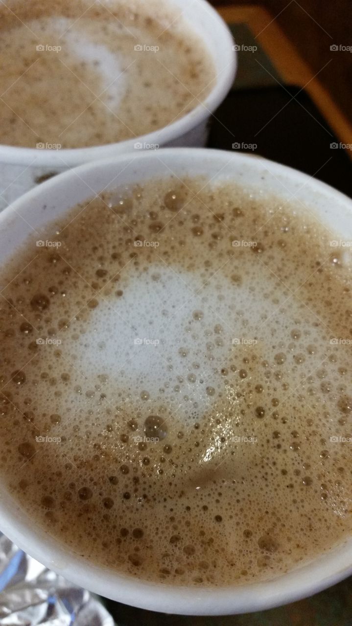 Delicious foam on top of a steaming vanilla latte