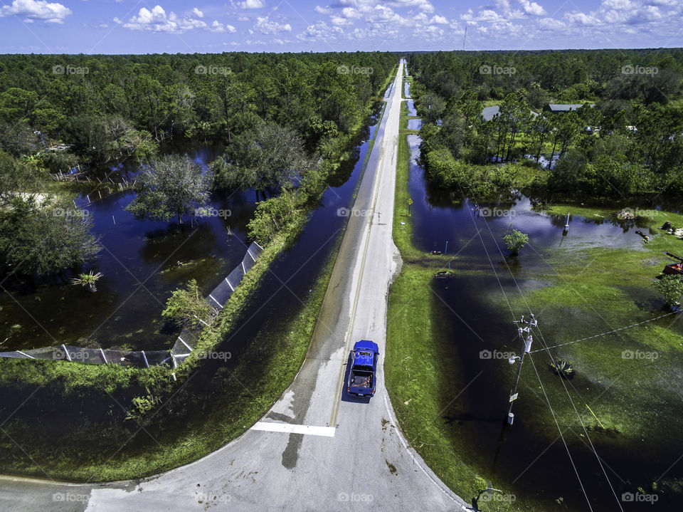 Truck going down a road after a hurricane flooded the area, hurricane Irma