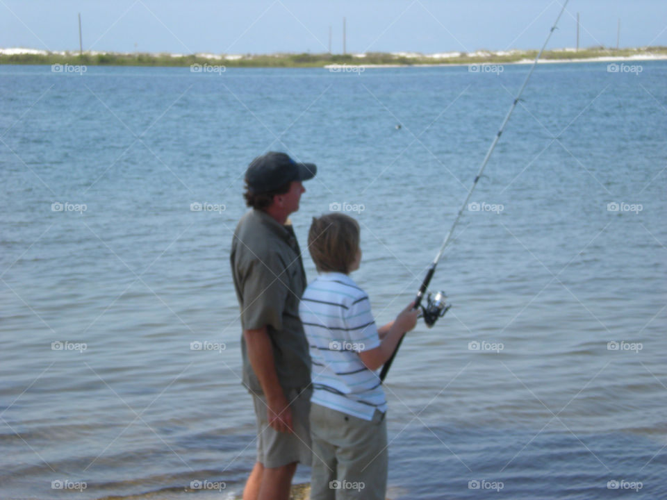 Father teaching son to fish