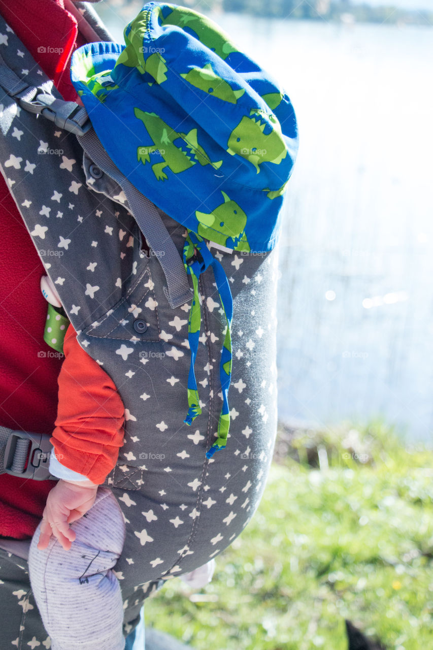 Father with infant baby in sling