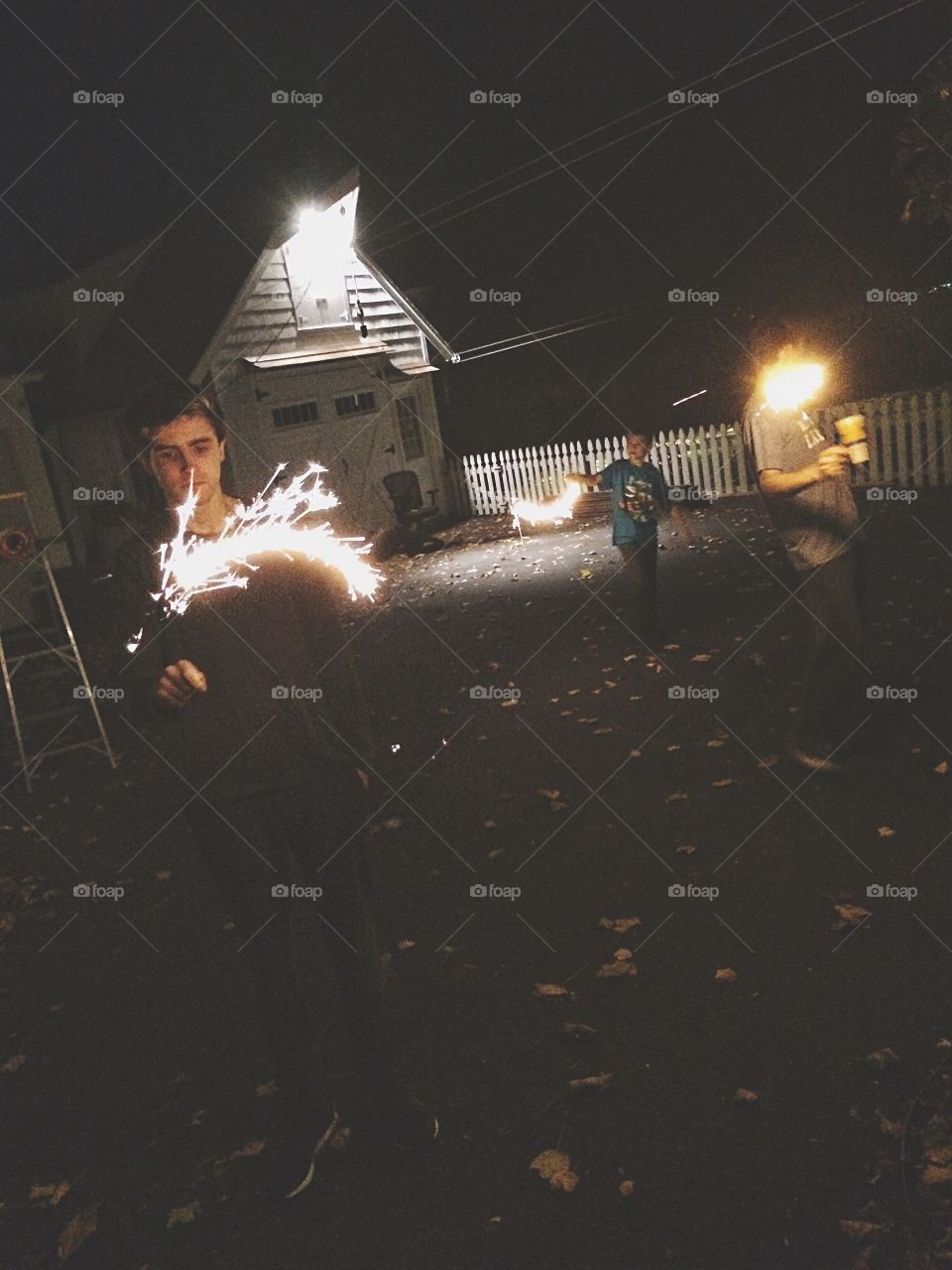 Group of people holding sparkler at night