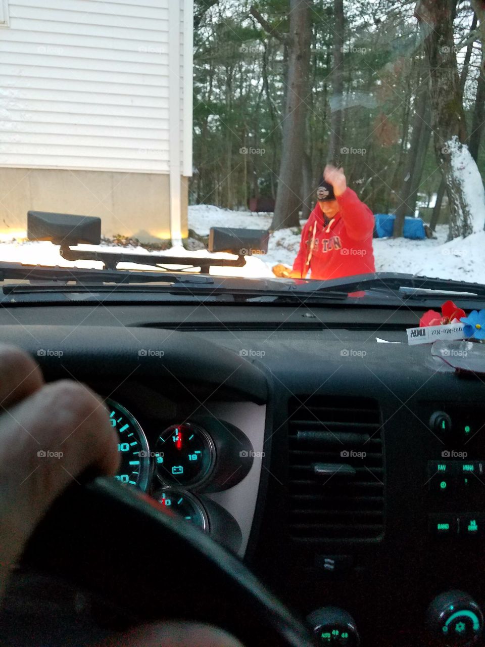 Putting on snow plow with hand signals from outside of truck.
