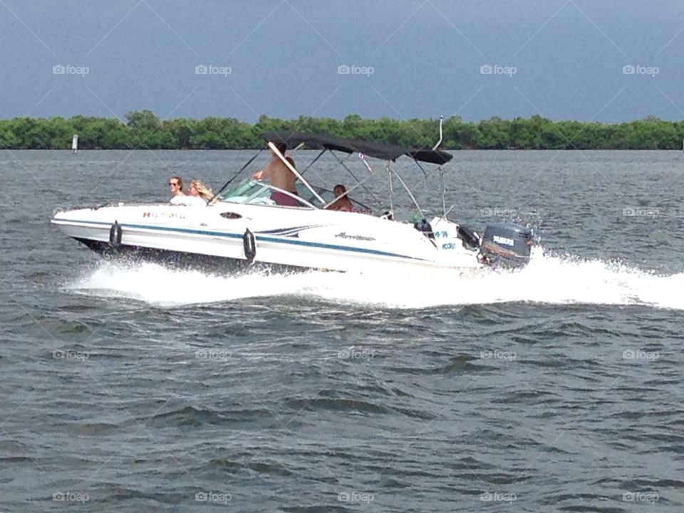 Boat speeding through gulf bay