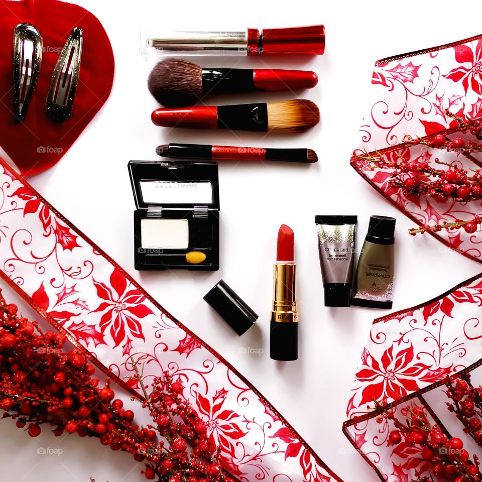 A red and white holiday inspired makeup flatlay.