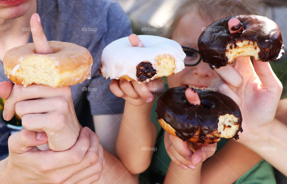 Children enjoying delicious donuts