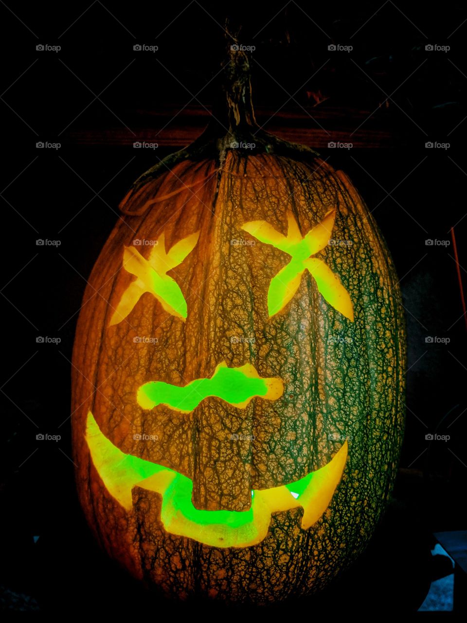 Glowing and happy hand carved pumpkin