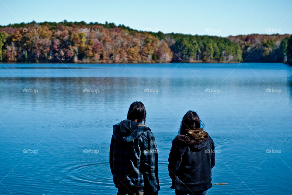 Girls Looking Over the Lake in Autumn Season 