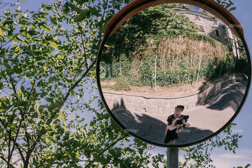 Travel selfie in a mirror on the road, version II. Couple traveling, summer memories. Italy 2018.