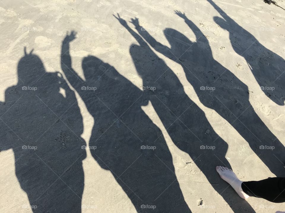 Shadows on the beach having fun