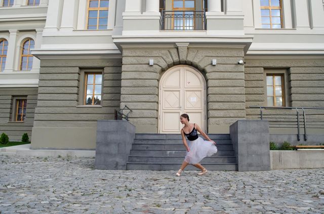 Young Female Ballerina Dancing Outside