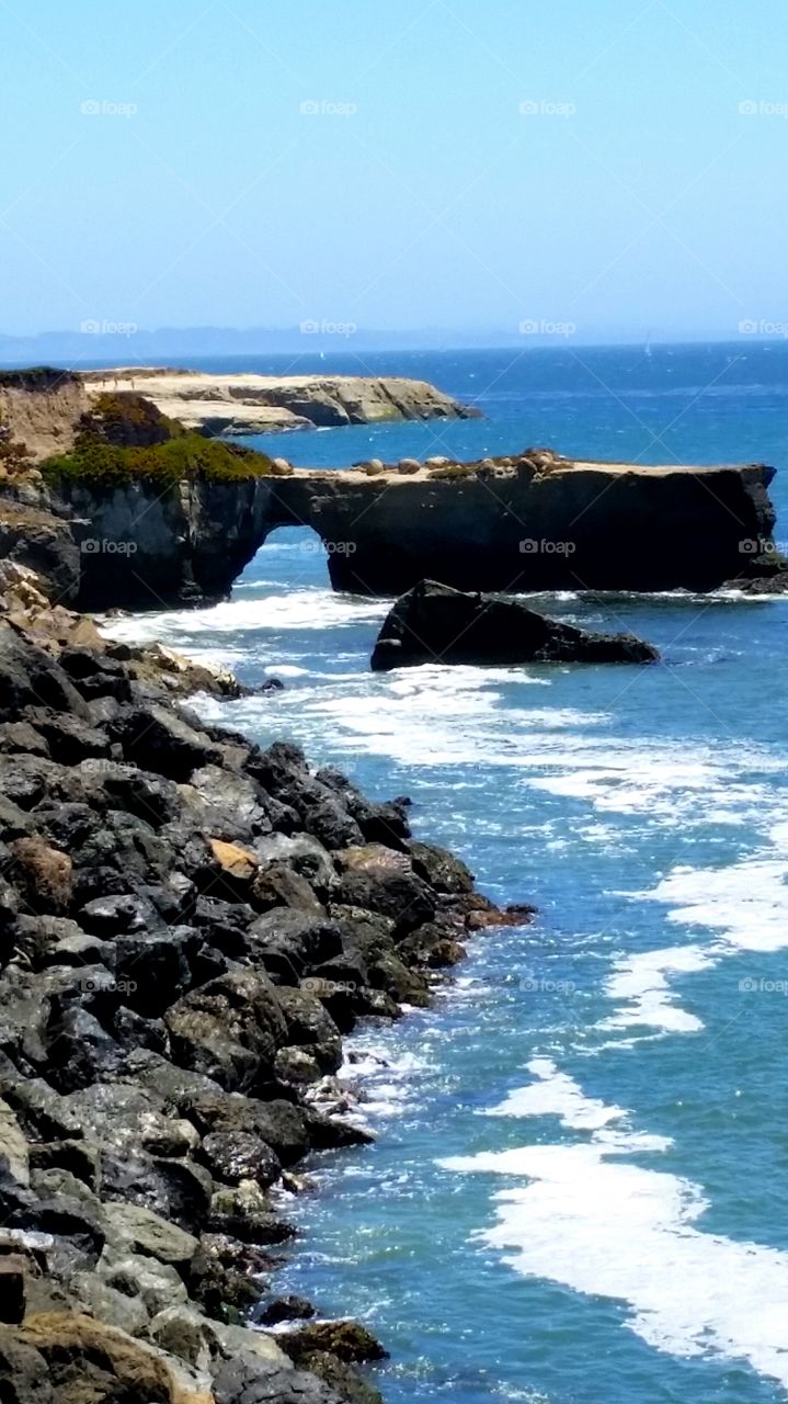 High angle view of rock arch in sea