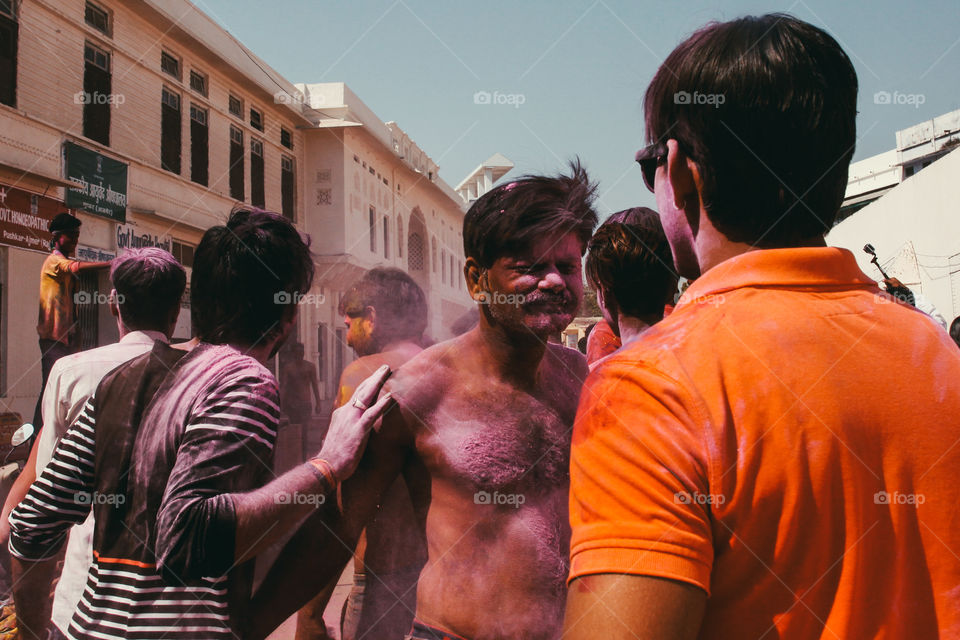 A man reacts to having pink powder thrown in his face by his friends at Holi festival in Pushkar, India.