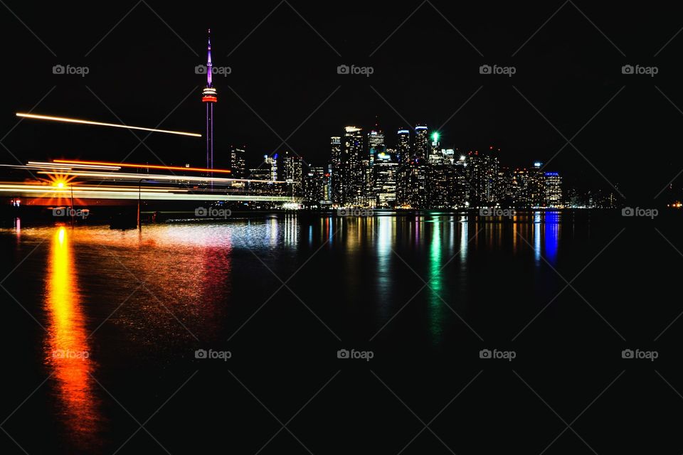 Long exposure of Toronto's skyline at night with ferry in motion