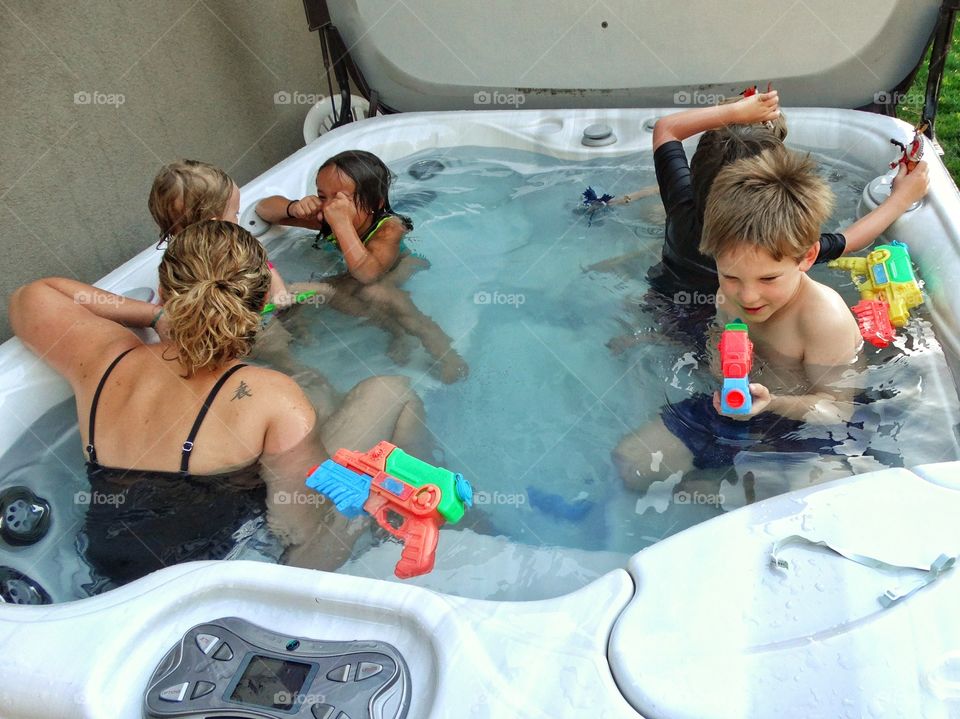 Hot Tub Fun. Mom In A Hot Tub With Lots Of Kids