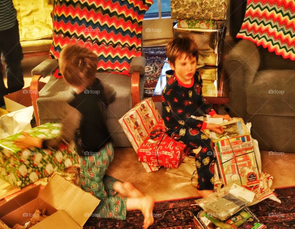 Opening Presents Christmas Morning. Joyful Childhood Holiday Tradition
