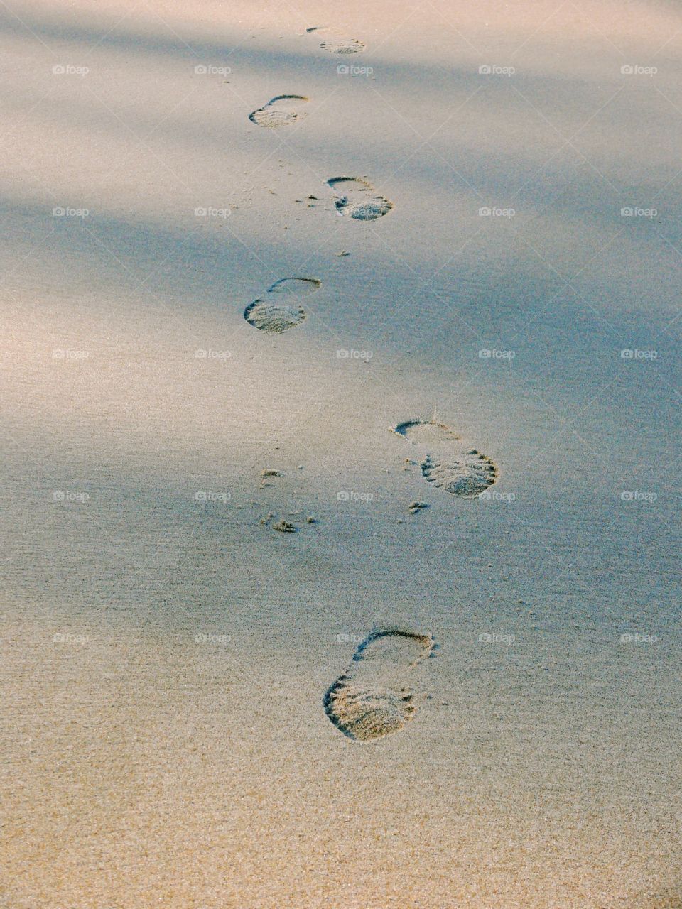 High angle view of shoe prints in sand at the beach in Rewal, Poland.