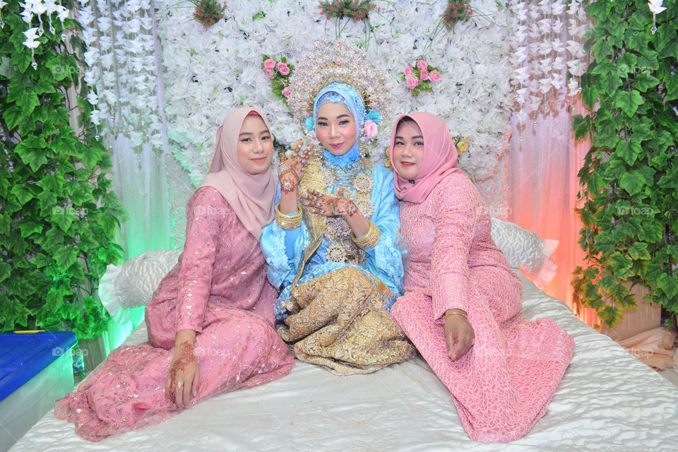 three womens wearing traditional hijab clothes from Indonesia