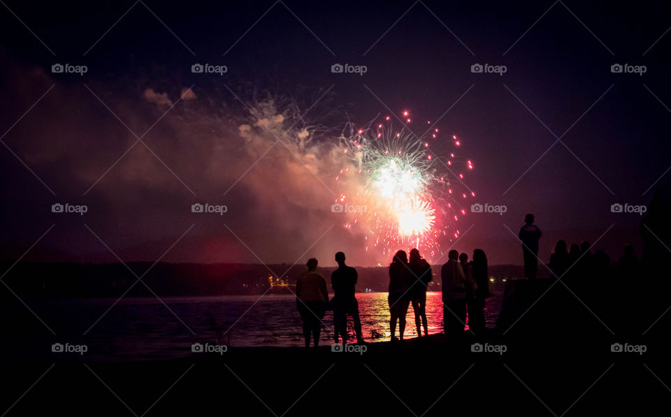 Silhouette of people watching salute