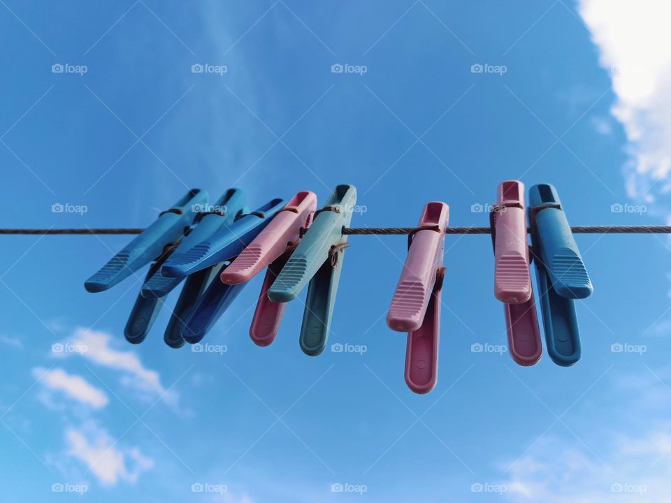 hanging clothespins against the blue sky.