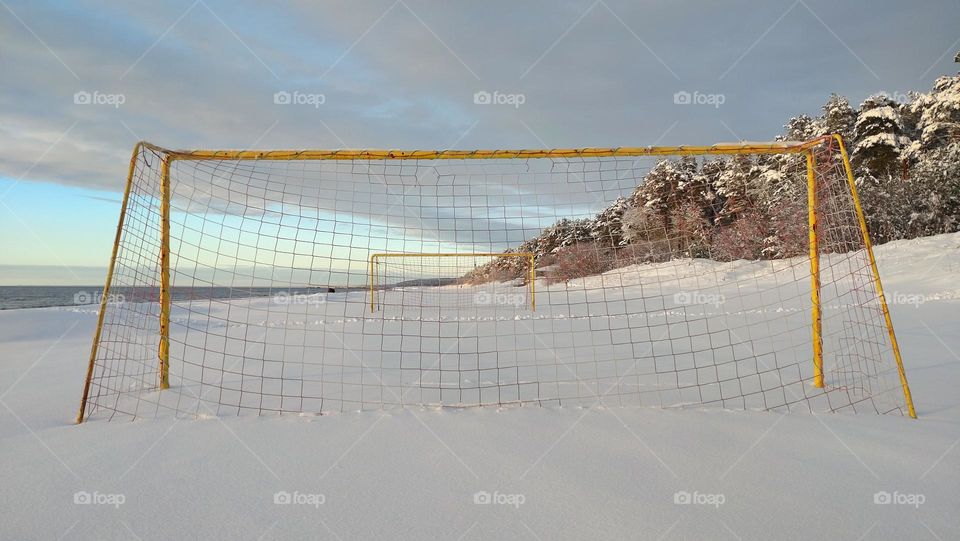 Football goal on the seashore in winter season🟨🟦❄️