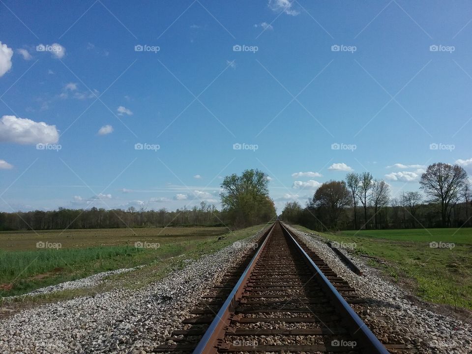 Railroad tracks near farmland.