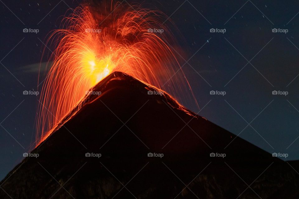 Eruption of volcan de fuego with long exposure lava trails.