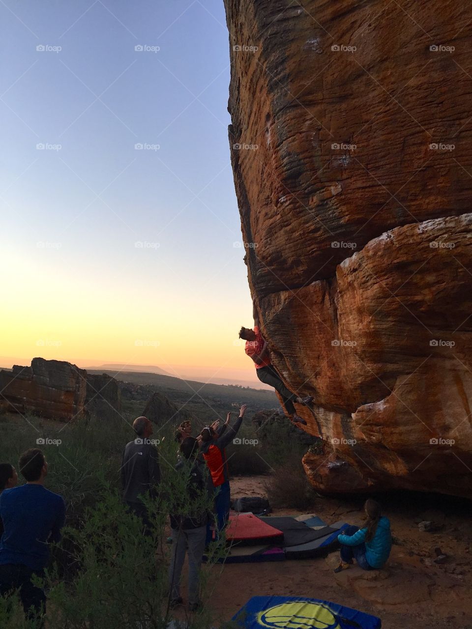 Rocklands by sunset. A rock climber makes a hard move in the golden hour.