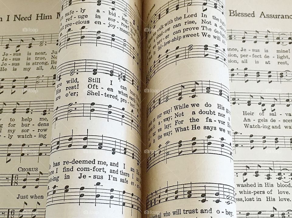 Old Christian hymnal book with pages rolled
