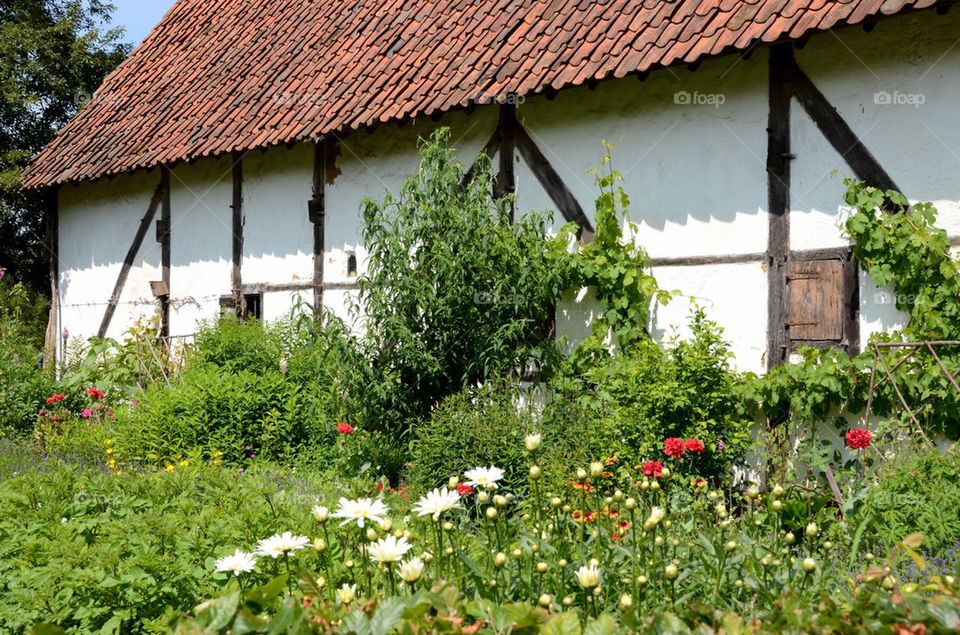 Flowers and plants before an old farm in Belgium.