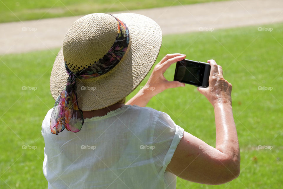 Phone. Camera phoneTaking a picture of a garden in an English stately home with a smartphone cell phone mobile phone camera 