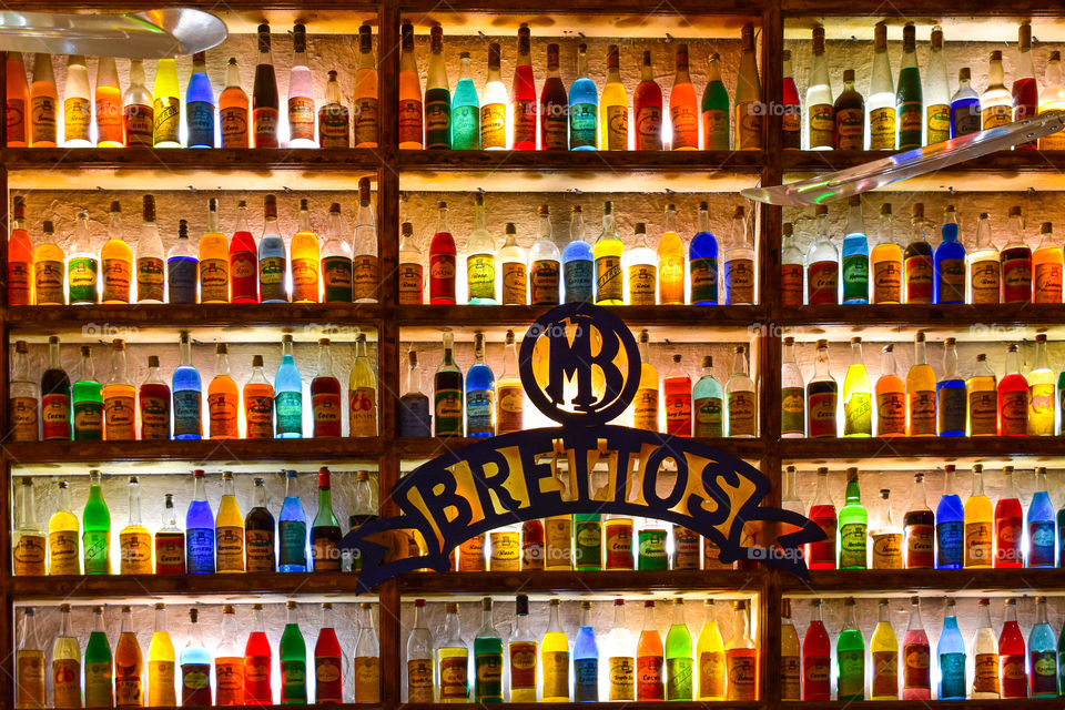 many colorful bottles in a shelf