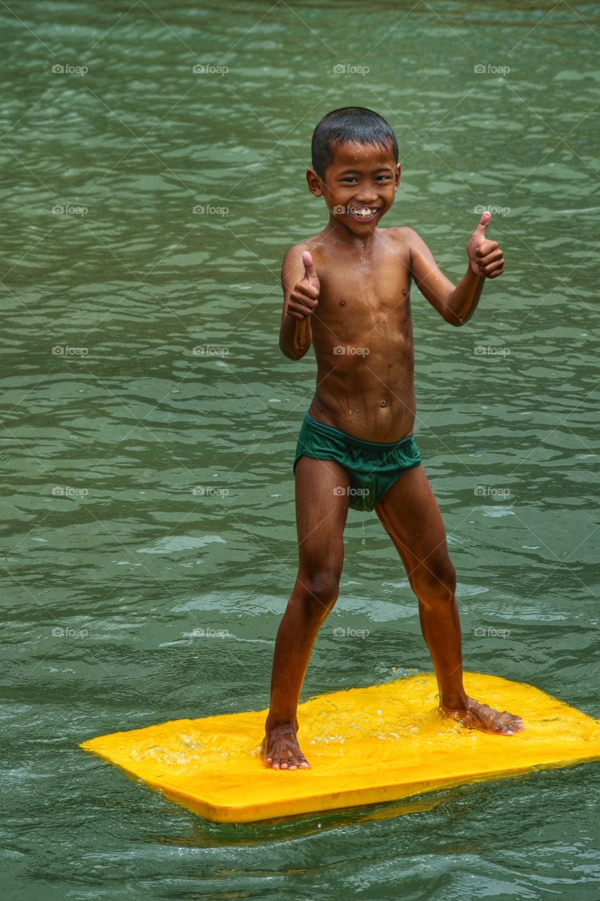 Smile face a boy when playing at water
