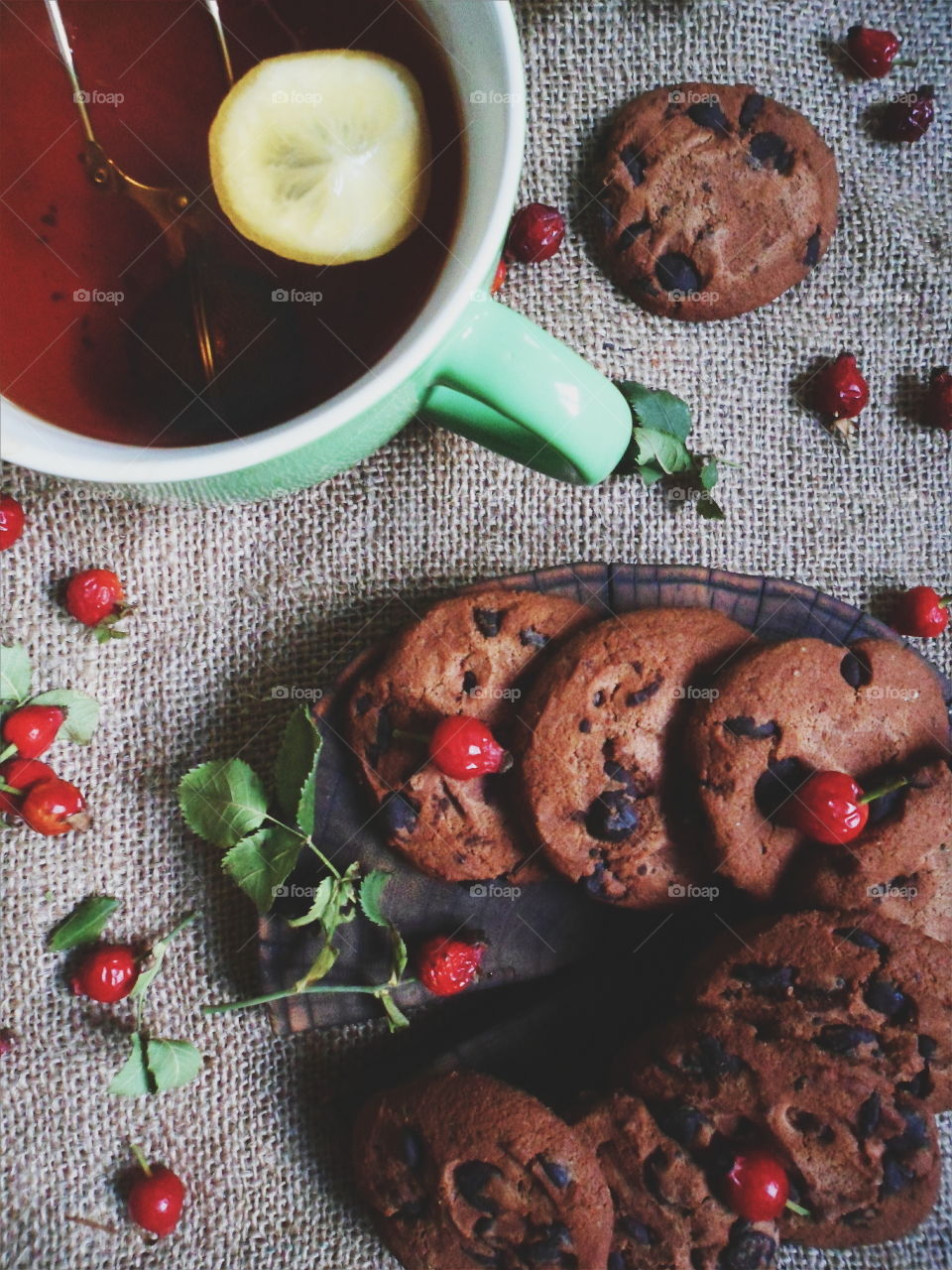 oatmeal cookies with chunks of chocolate and a cup of tea, dessert