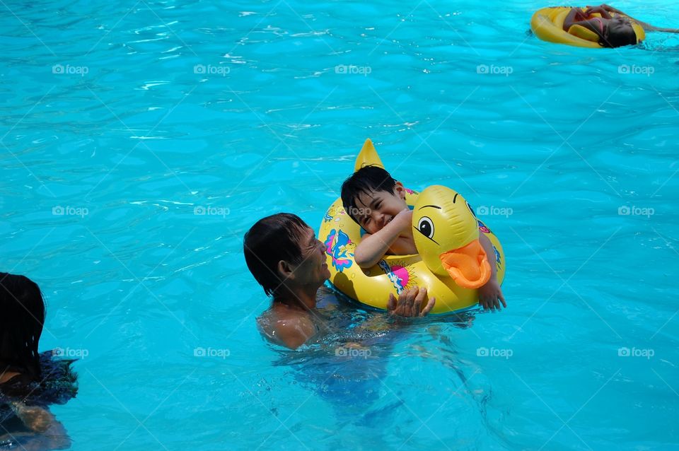 Man and kid in a pool