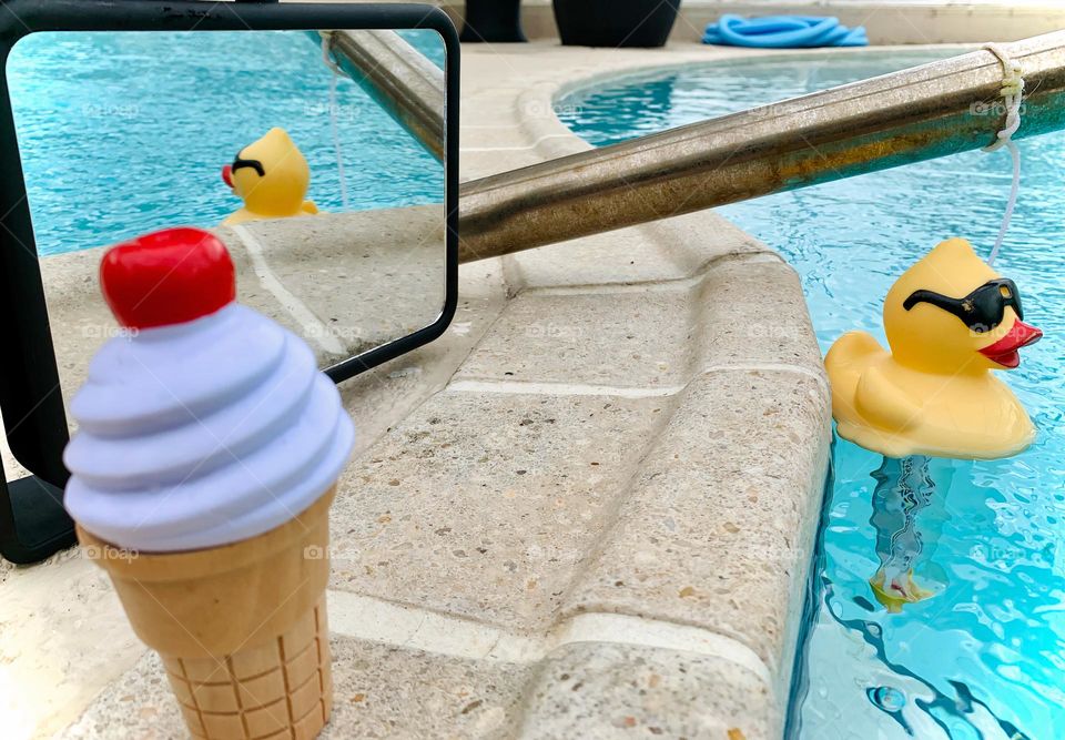 Duck Saying Hi Floating In The Pool Mirror Reflection With Its Ice Cream Waiting