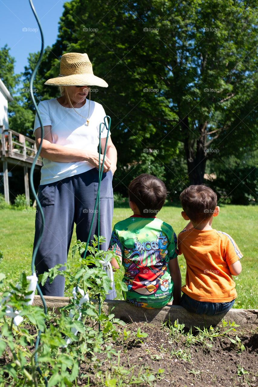 Grandmother talks to boys about the garden