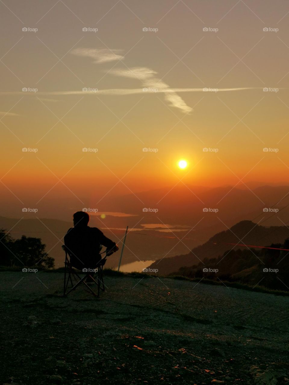 Sunset and amazing views. Man enjoy the sunset... Nature and people. Mountains and lakes. Autumn colors.