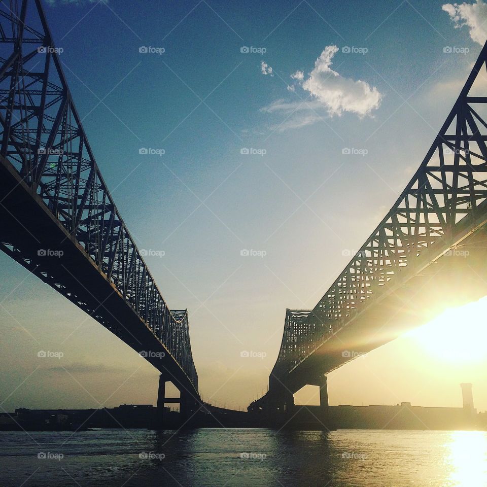 It's a man thorough fare in New Orleans. It gets us across the mighty Mississippi River to access the swaps and suburbs. We are lucky enough to have levee access to snap extraordinary photos of these behemoth bridges. 