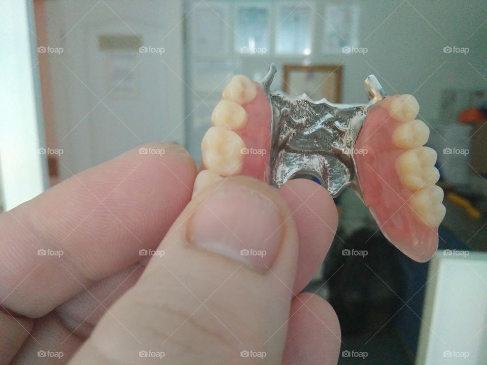 Dentures in hand