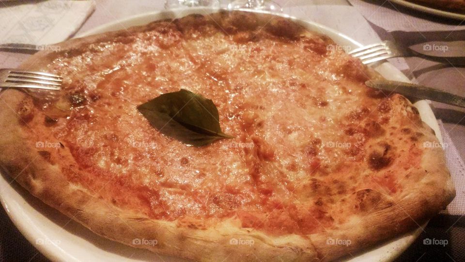 Pizza Margherita served at table