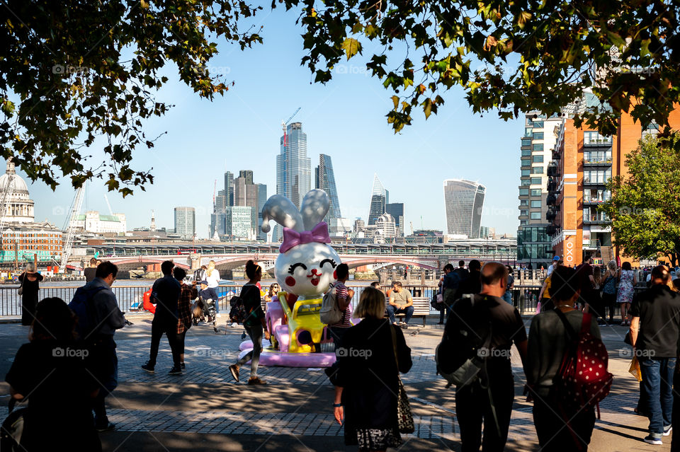 Walking The Queen's Walk. The Thames River passage with London's financial district in distance called Square Mile. London. UK.