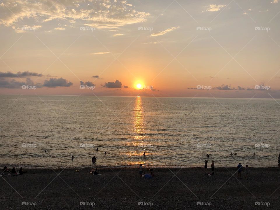 Sunset by the beach featuring Golden horizons.