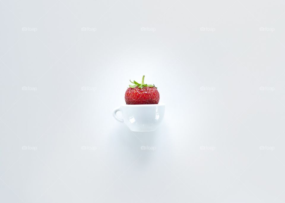 Strawberry on white background. Strawberry in tiny cup 